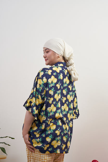 Back-side profile of Buttoned Belle Blouse in Lemon Dream with Flutter Flair Pants in Lemonade, highlighting loose fit and modest coverage over back