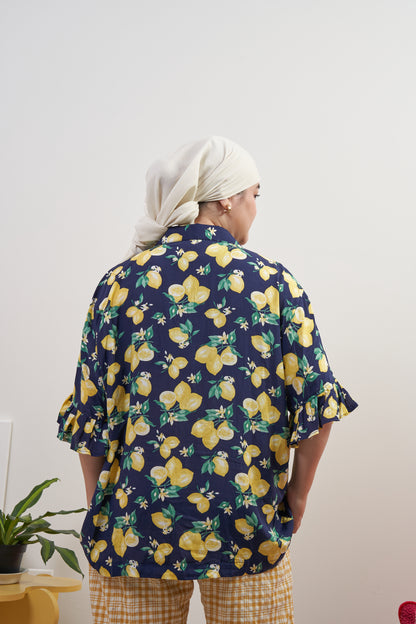 Full back view of Buttoned Belle Blouse in Lemon Dream, styled with Flutter Flair Pants in Lemonade, showing loose fit with modest coverage and ruffled sleeves.