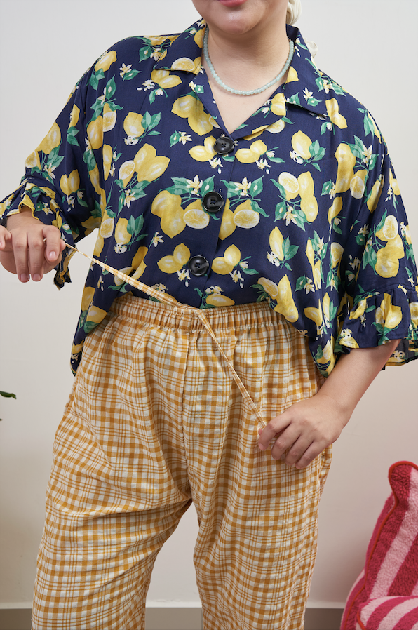 Close-up of Flutter Flair Pants in Lemonade, showing adjustable drawstring waist with Buttoned Belle Blouse in Lemon Dream tucked in